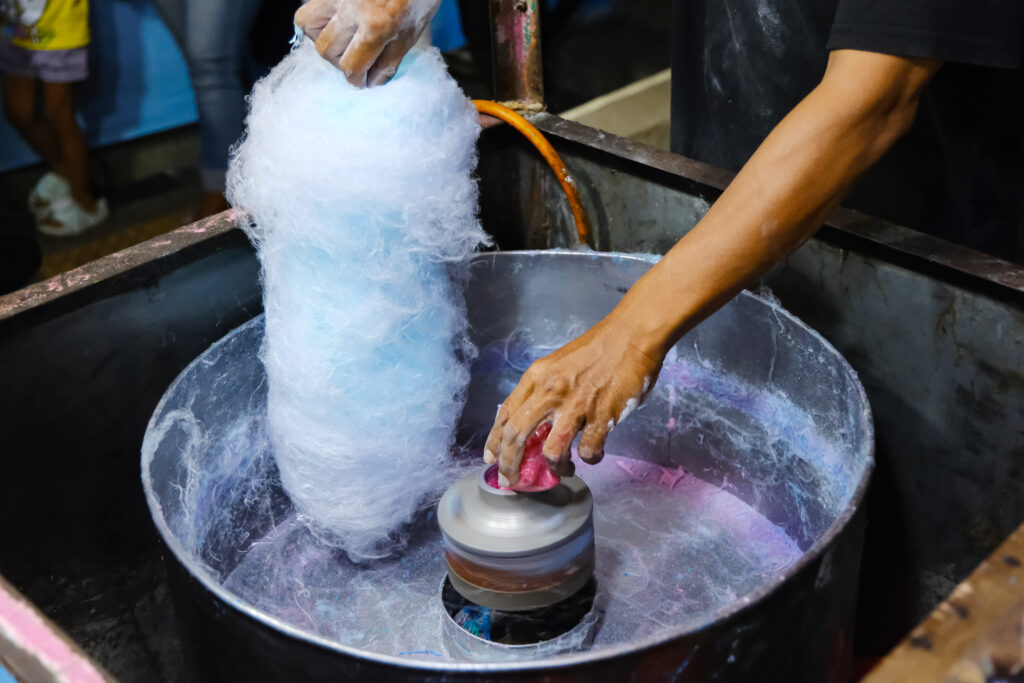 Man making blue cotton candy at street food stall 2025 03 05 05 16 52 utc